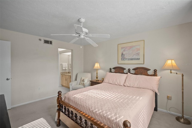 4530 Pinebrook Cir Unit 109, Bradenton, FL 34209 - bedroom featuring light carpet, baseboards, connected bathroom, a ceiling fan, and a textured ceiling