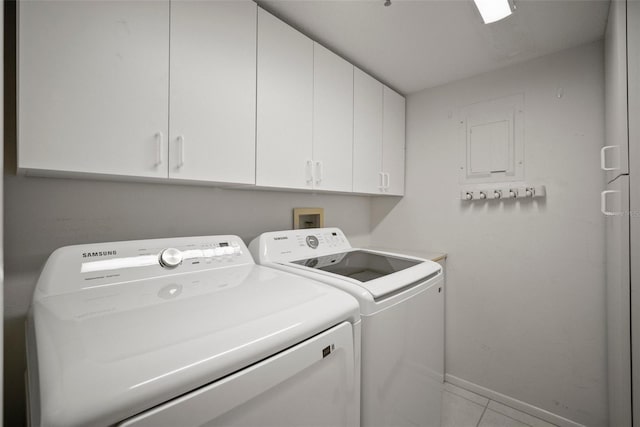 4530 Pinebrook Cir Unit 109, Bradenton, FL 34209 - laundry area with cabinet space, washer and dryer, baseboards, and light tile patterned floors