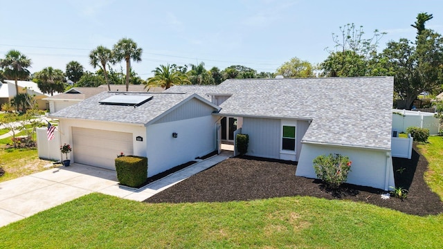 4308 Kingston Loop, Sarasota, FL 34238 - view of front of home with an attached garage, roof with shingles, and concrete driveway