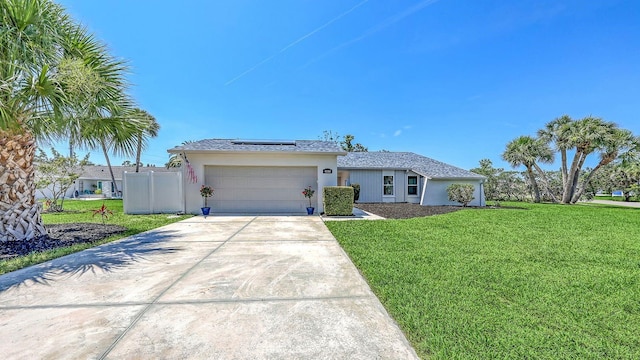 4308 Kingston Loop, Sarasota, FL 34238 - single story home featuring a front lawn, solar panels, driveway, a garage, and stucco siding