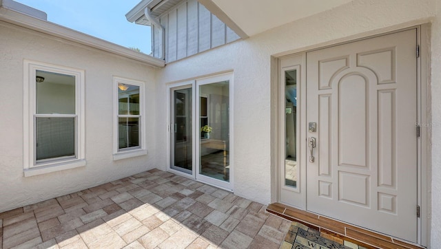 4308 Kingston Loop, Sarasota, FL 34238 - property entrance with stucco siding and a patio