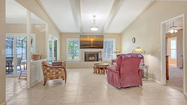 4308 Kingston Loop, Sarasota, FL 34238 - living area featuring a tiled fireplace, light tile patterned flooring, beam ceiling, and baseboards