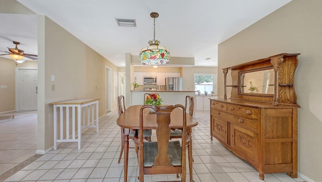 4308 Kingston Loop, Sarasota, FL 34238 - dining room with a ceiling fan, light tile patterned floors, and baseboards