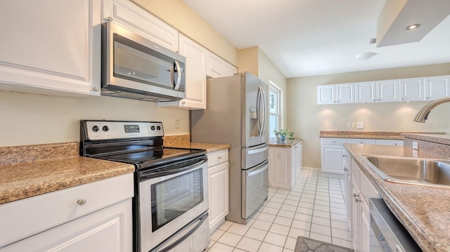 4308 Kingston Loop, Sarasota, FL 34238 - kitchen featuring appliances with stainless steel finishes, a sink, light tile patterned floors, white cabinets, and light countertops