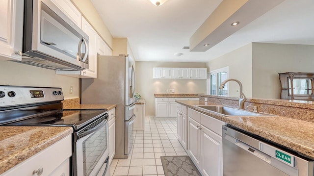 4308 Kingston Loop, Sarasota, FL 34238 - kitchen with appliances with stainless steel finishes, a sink, light countertops, white cabinets, and recessed lighting