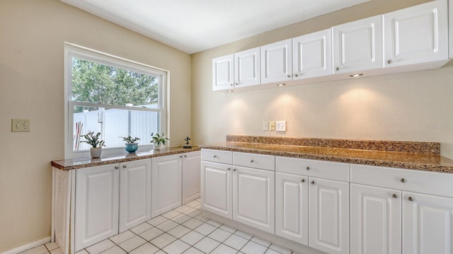 4308 Kingston Loop, Sarasota, FL 34238 - kitchen featuring white cabinets and light tile patterned floors