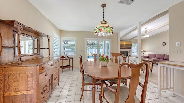 4308 Kingston Loop, Sarasota, FL 34238 - dining room with lofted ceiling, baseboards, a fireplace, and light tile patterned floors