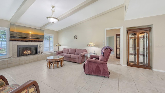 4308 Kingston Loop, Sarasota, FL 34238 - living room with light tile patterned floors, healthy amount of natural light, a tiled fireplace, and baseboards