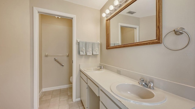 4308 Kingston Loop, Sarasota, FL 34238 - full bath with double vanity, toilet, tile patterned floors, and baseboards