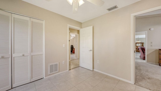 4308 Kingston Loop, Sarasota, FL 34238 - unfurnished bedroom with a closet, light tile patterned flooring, baseboards, and a ceiling fan