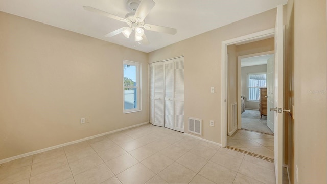 4308 Kingston Loop, Sarasota, FL 34238 - unfurnished bedroom featuring baseboards, a closet, light tile patterned flooring, and ceiling fan