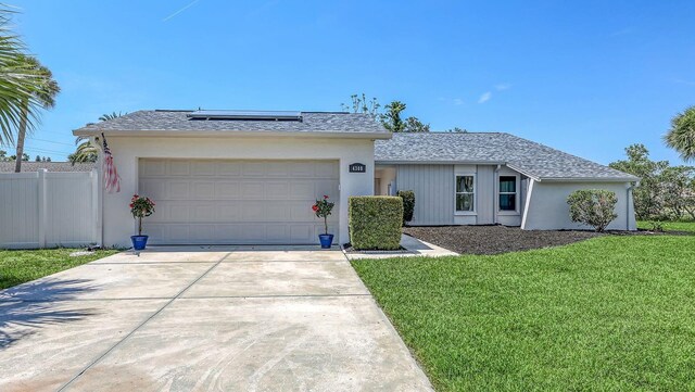 4308 Kingston Loop, Sarasota, FL 34238 - ranch-style house featuring roof mounted solar panels, an attached garage, driveway, and stucco siding