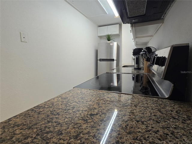 4213 E Michigan St Unit 4213, Orlando, FL 32812 - kitchen with freestanding refrigerator, exhaust hood, dark countertops, white cabinets, and electric stove