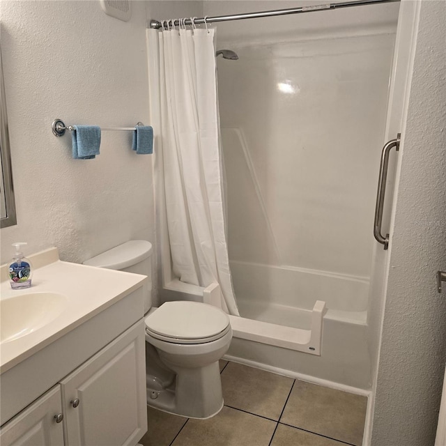 4213 E Michigan St Unit 4213, Orlando, FL 32812 - bathroom featuring tile patterned flooring, vanity, toilet, shower / bath combo with shower curtain, and a textured wall