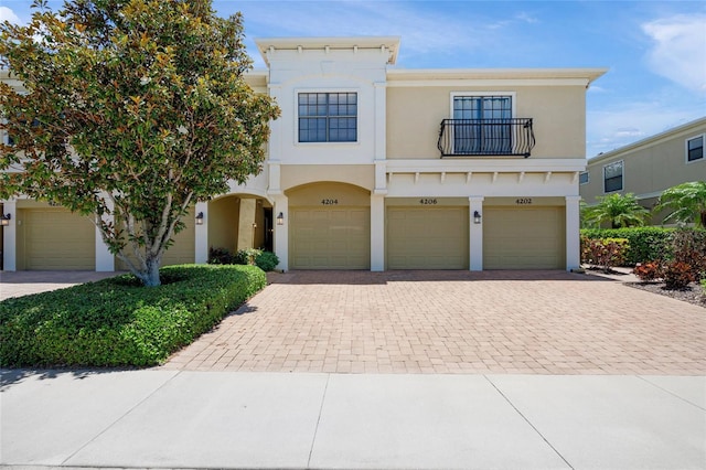 4204 Overture Cir # 4204, Bradenton, FL 34209 - view of front of house featuring a balcony, decorative driveway, an attached garage, and stucco siding