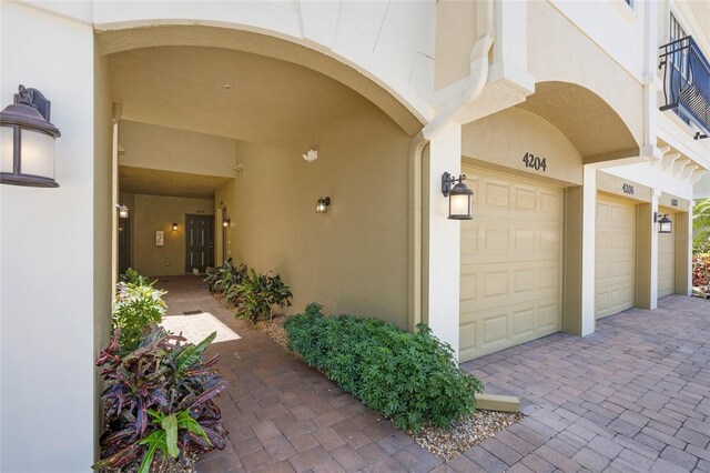4204 Overture Cir # 4204, Bradenton, FL 34209 - entrance to property with an attached garage, stucco siding, and decorative driveway