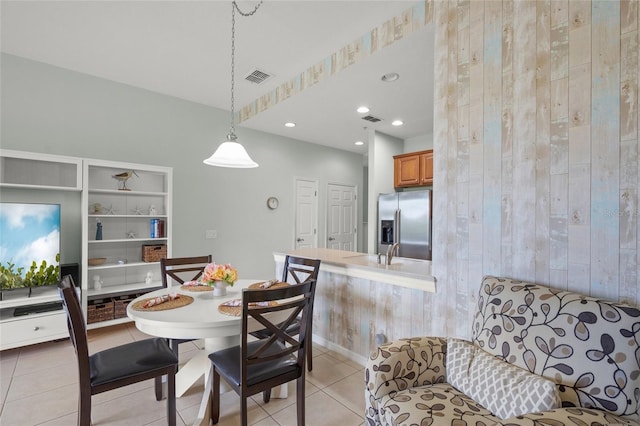 4204 Overture Cir # 4204, Bradenton, FL 34209 - dining space featuring light tile patterned flooring, wood walls, and recessed lighting