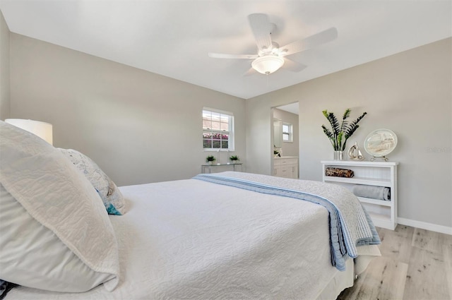 9822 Desoto Ct, Bradenton, FL 34210 - bedroom with light wood-style flooring, baseboards, and a ceiling fan
