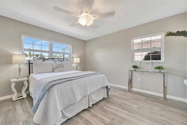 9822 Desoto Ct, Bradenton, FL 34210 - bedroom featuring light wood-style floors, baseboards, and a ceiling fan