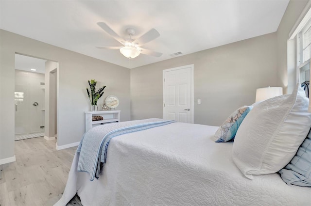 9822 Desoto Ct, Bradenton, FL 34210 - bedroom with light wood-style flooring, baseboards, ceiling fan, and connected bathroom