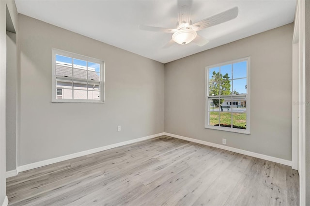 9822 Desoto Ct, Bradenton, FL 34210 - spare room featuring plenty of natural light, wood finished floors, baseboards, and ceiling fan