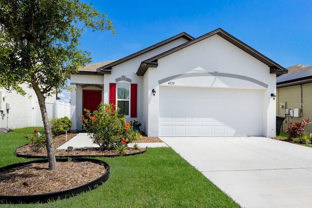 4739 Reisswood Loop, Palmetto, FL 34221 - ranch-style house with stucco siding, an attached garage, concrete driveway, and a front yard