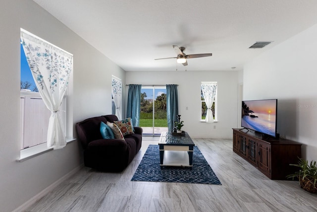 4739 Reisswood Loop, Palmetto, FL 34221 - living room with ceiling fan, wood finished floors, and baseboards