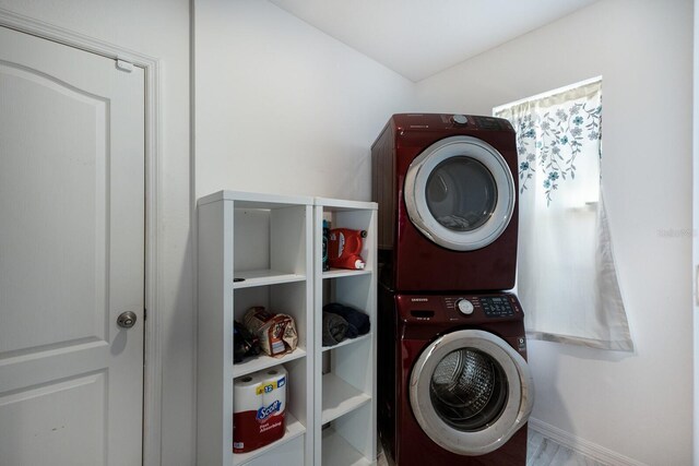4739 Reisswood Loop, Palmetto, FL 34221 - washroom featuring stacked washing machine and dryer and baseboards