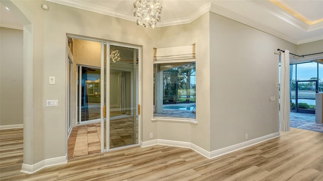 6914 Dominion Ln, Lakewood Ranch, FL 34202 - spare room featuring wood finished floors, ornamental molding, a chandelier, and baseboards