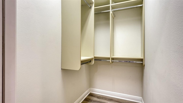 6914 Dominion Ln, Lakewood Ranch, FL 34202 - walk in closet featuring wood finished floors