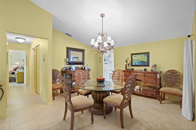 4109 Carriage Dr Unit 23, Sarasota, FL 34241 - dining space with a chandelier, lofted ceiling, and light tile patterned flooring