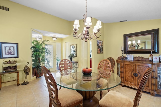 4109 Carriage Dr Unit 23, Sarasota, FL 34241 - dining room with light tile patterned floors and a chandelier