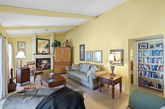 4109 Carriage Dr Unit 23, Sarasota, FL 34241 - living room featuring light tile patterned floors, a glass covered fireplace, and baseboards