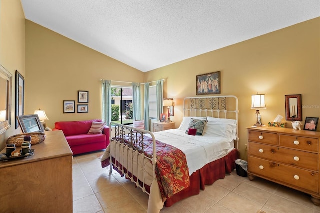 4109 Carriage Dr Unit 23, Sarasota, FL 34241 - bedroom featuring light tile patterned flooring, lofted ceiling, and a textured ceiling