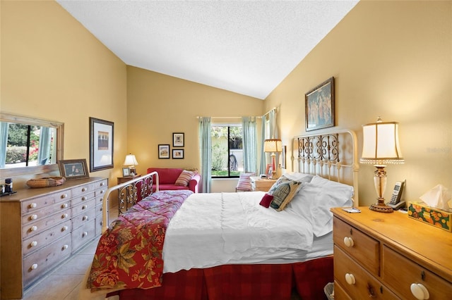 4109 Carriage Dr Unit 23, Sarasota, FL 34241 - tiled bedroom featuring vaulted ceiling, multiple windows, and a textured ceiling