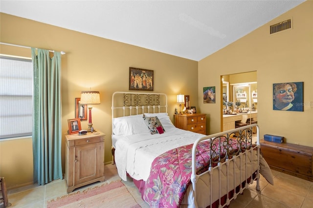 4109 Carriage Dr Unit 23, Sarasota, FL 34241 - bedroom featuring lofted ceiling, tile patterned flooring, and connected bathroom