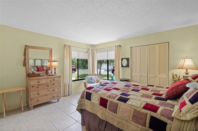 4109 Carriage Dr Unit 23, Sarasota, FL 34241 - bedroom featuring a textured ceiling, light tile patterned floors, access to outside, and a closet