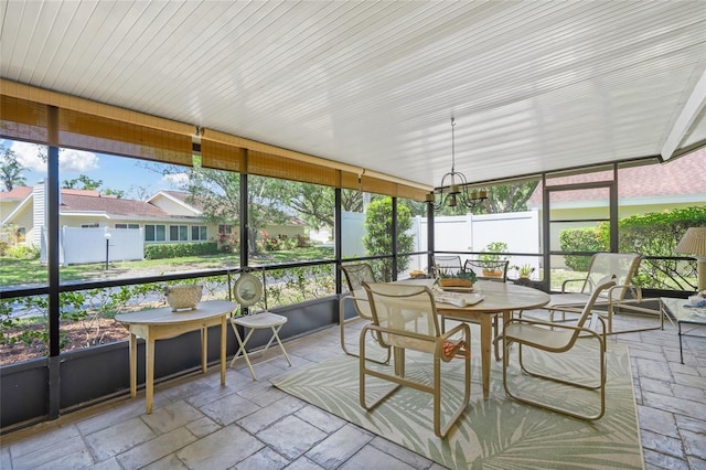 4109 Carriage Dr Unit 23, Sarasota, FL 34241 - sunroom featuring outdoor dining area and a chandelier