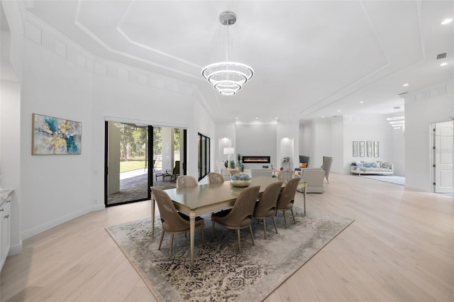 7051 Turtle Ln, Sarasota, FL 34241 - dining space with light wood-type flooring, a chandelier, a tray ceiling, and recessed lighting