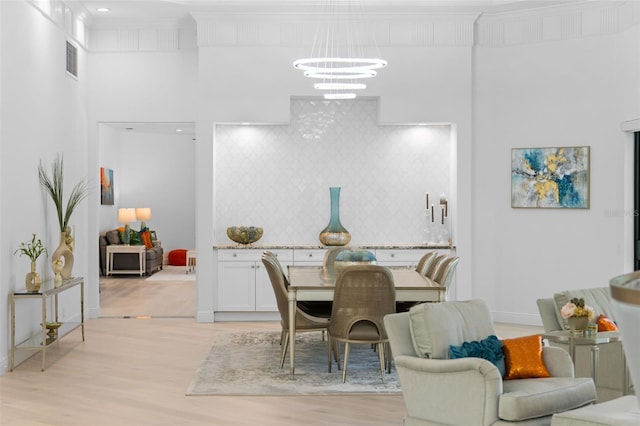 7051 Turtle Ln, Sarasota, FL 34241 - dining area featuring a chandelier and light wood finished floors