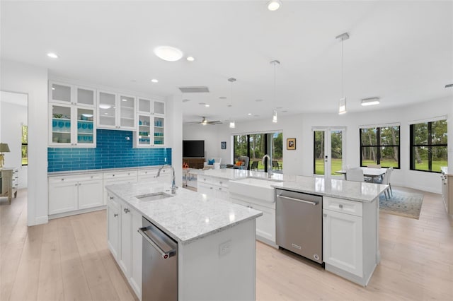 7051 Turtle Ln, Sarasota, FL 34241 - kitchen featuring a center island with sink, dishwasher, open floor plan, white cabinetry, and a ceiling fan