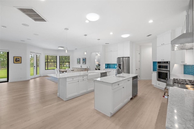 7051 Turtle Ln, Sarasota, FL 34241 - kitchen with a large island with sink, wall chimney range hood, tasteful backsplash, recessed lighting, and open floor plan