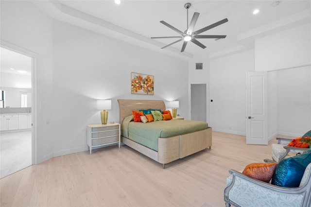 7051 Turtle Ln, Sarasota, FL 34241 - bedroom with light wood-style flooring, a high ceiling, recessed lighting, ceiling fan, and connected bathroom