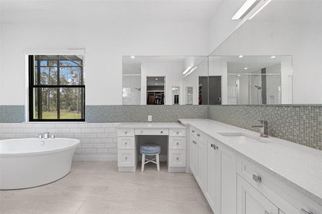 7051 Turtle Ln, Sarasota, FL 34241 - bathroom featuring a stall shower, vanity, a freestanding bath, tile walls, and a wainscoted wall