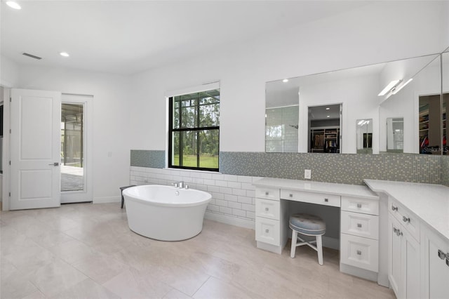 7051 Turtle Ln, Sarasota, FL 34241 - full bath with a soaking tub, a spacious closet, tile walls, recessed lighting, and tile patterned flooring