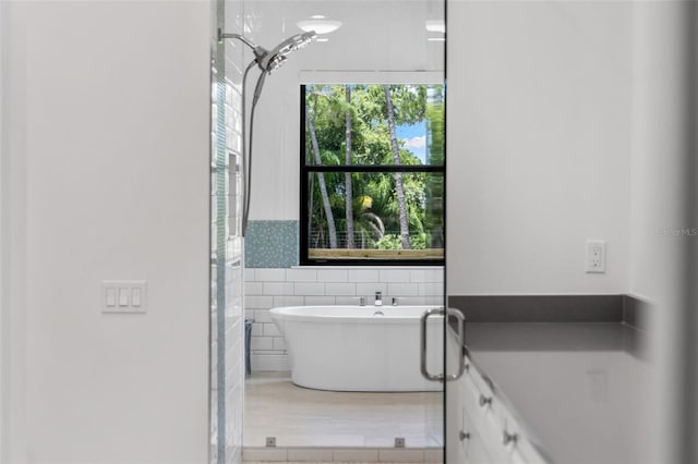 7051 Turtle Ln, Sarasota, FL 34241 - full bath featuring a soaking tub, tile walls, and a wainscoted wall
