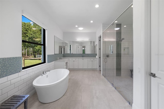 7051 Turtle Ln, Sarasota, FL 34241 - bathroom with a stall shower, a freestanding bath, vanity, tile walls, and recessed lighting