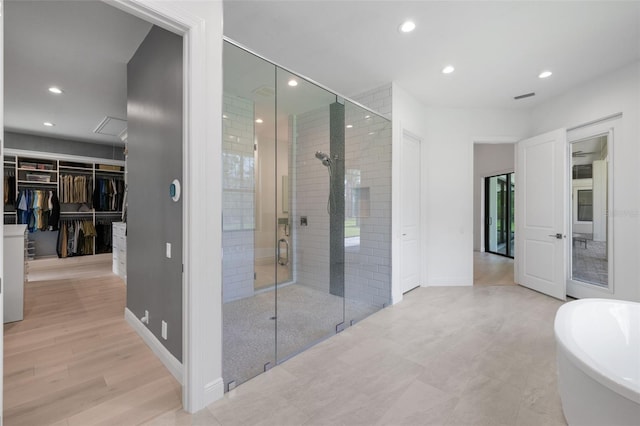 7051 Turtle Ln, Sarasota, FL 34241 - bathroom with a stall shower, a freestanding tub, recessed lighting, and a walk in closet