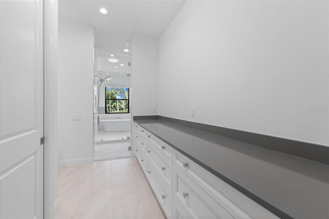 7051 Turtle Ln, Sarasota, FL 34241 - bathroom featuring a freestanding tub, recessed lighting, an enclosed shower, and vanity