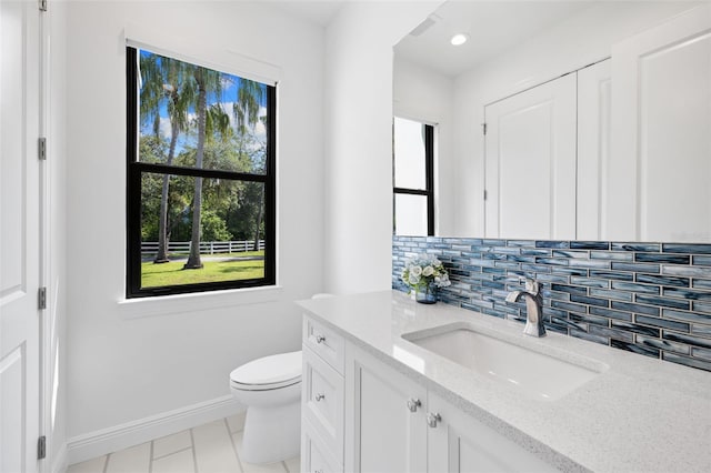 7051 Turtle Ln, Sarasota, FL 34241 - bathroom featuring vanity, decorative backsplash, tile patterned floors, and recessed lighting